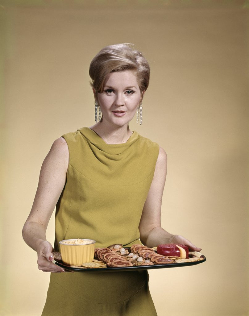 Detail of 1960s Blonde Woman Looking At Camera Serving Snacks Hors d'Oeuvres On Tray by Corbis