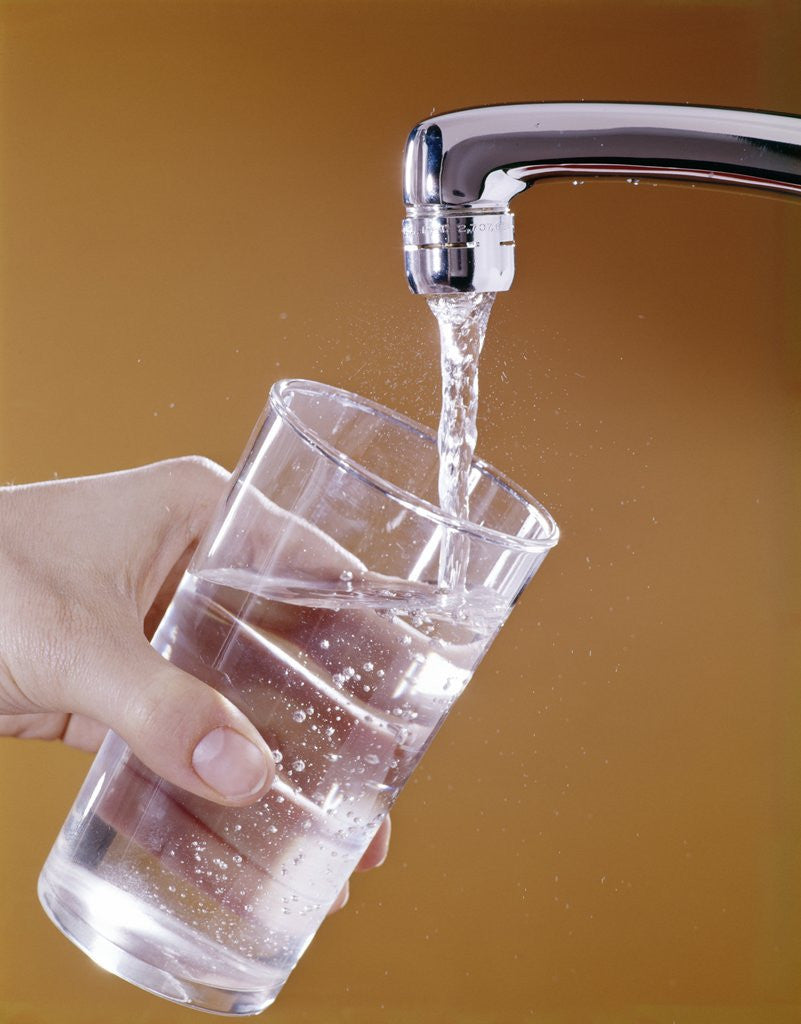 Detail of 1970s Hand Holding Glass Under Running Water Faucet by Anonymous