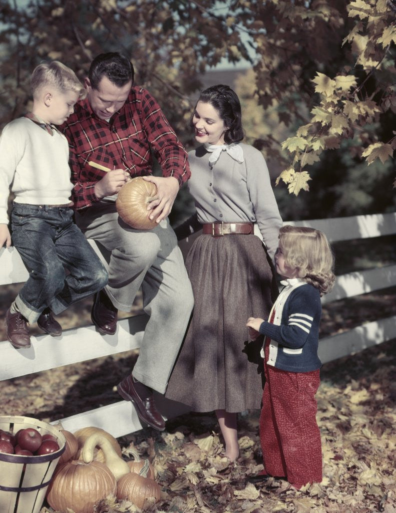 Detail of 1950s Family Father Mother Son And Daughter Outdoor Carving A Pumpkin by Corbis