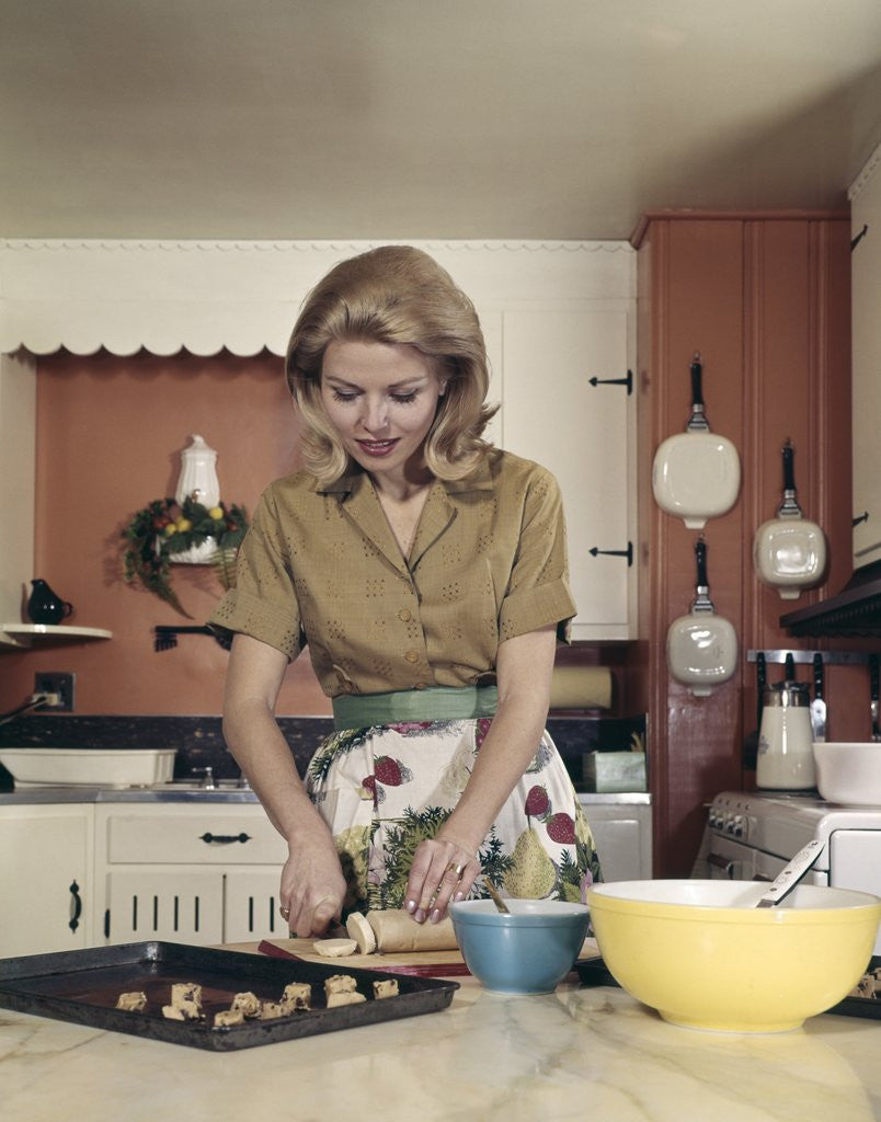Detail of 1960s Woman Kitchen Baking Cookies Apron Mixing Bowl by Corbis