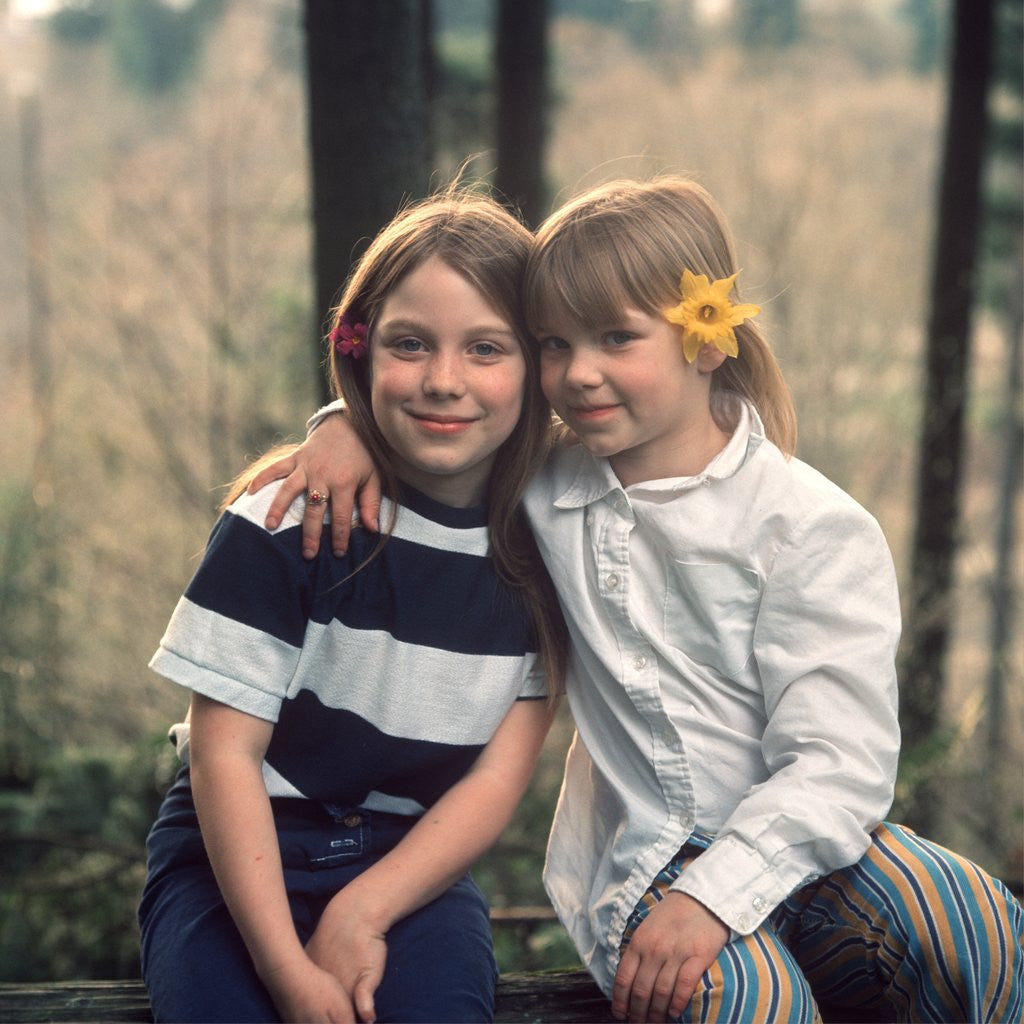 Detail of two Young Girls With Flowers In Their Hair Sitting Outside Retro 1970 1970s by Anonymous