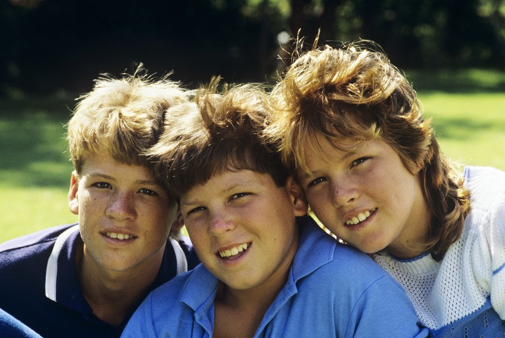 Detail of 1980s Two Brothers And Their Sister Posed Heads Together Smiling Looking At Camera by Anonymous