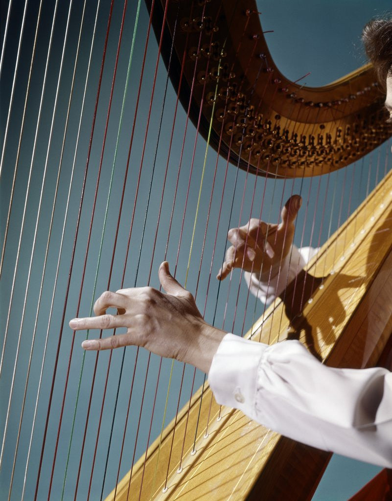 Detail of 1960 1960s Retro Close Up Of Womans Hands Playing Harp Plucking Strings by Anonymous