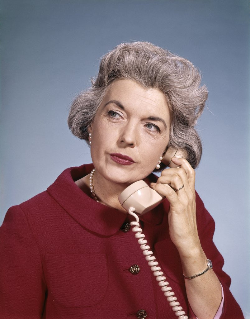 Detail of 1960s Senior Middle Aged Woman Red Blouse Serious Expression Talking On Telephone by Anonymous