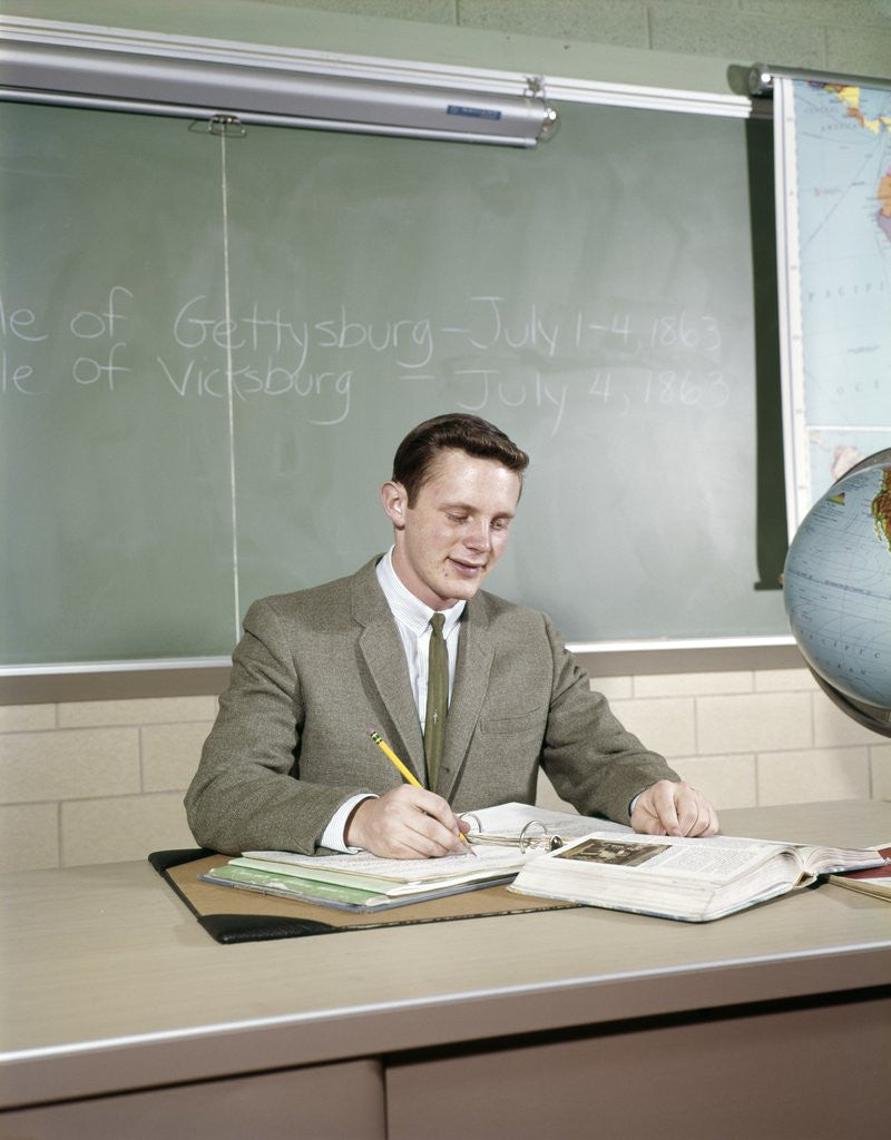 Detail of 1960s Student Studying Desk Globe Open Book Writing Chalkboard High School by Anonymous