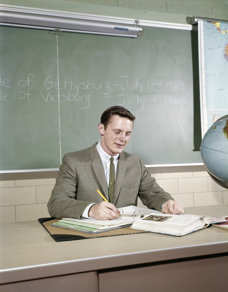 Detail of 1960s Student Studying Desk Globe Open Book Writing Chalkboard High School by Corbis