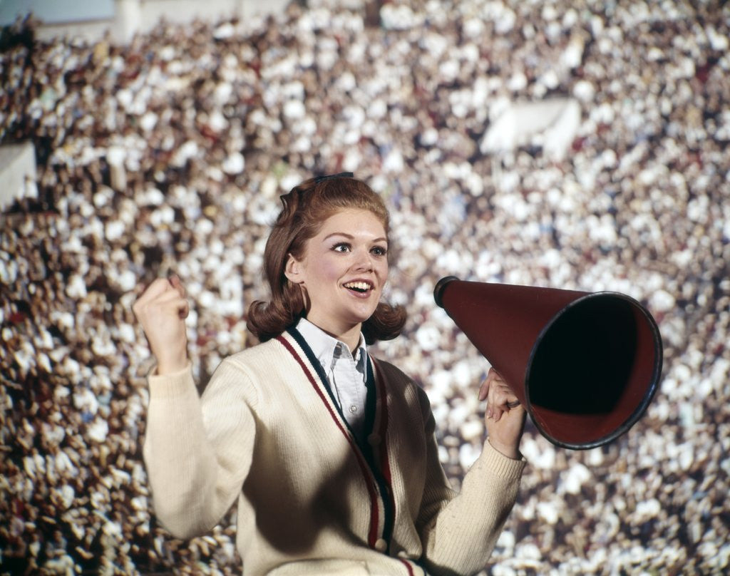 Detail of 1960s Female Cheerleader Cheering Red Megaphone Wearing Sweater by Anonymous