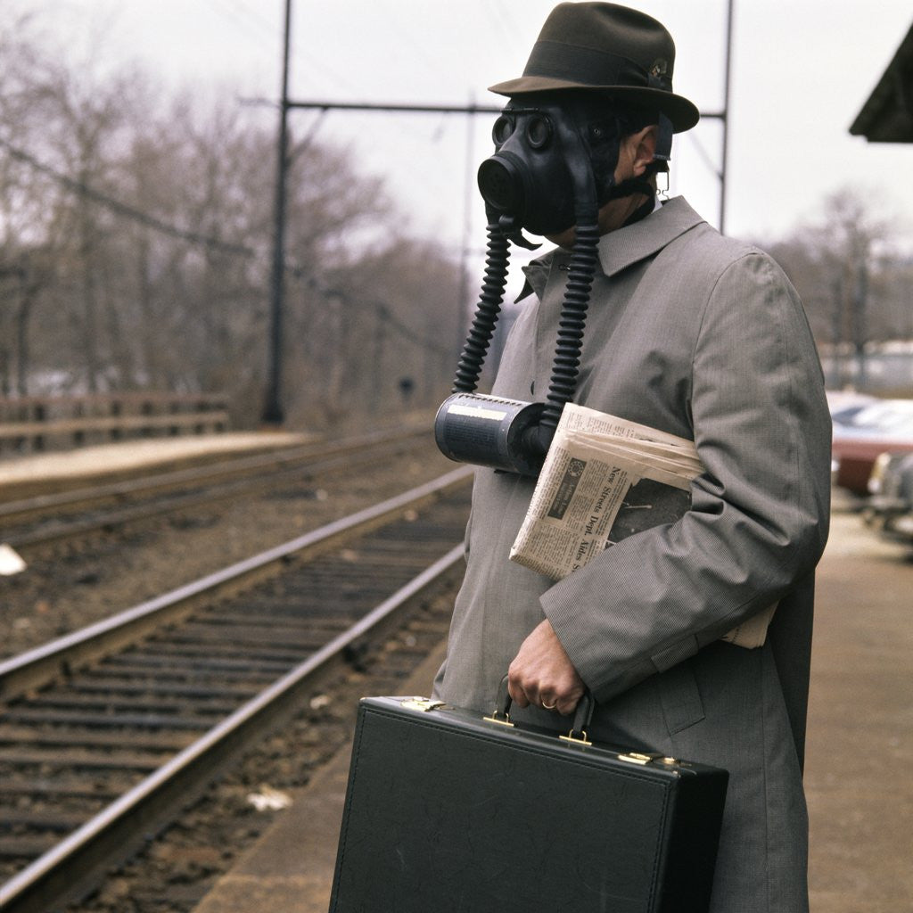 Detail of 1970s 1960s Man Commuter Waiting For Train Wearing Gas Mask Pollution by Anonymous