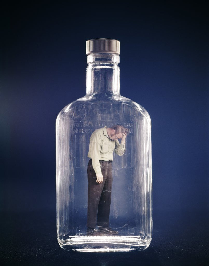 Detail of 1960s Slumped Over Alcoholic Man Holding Whiskey Bottle Trapped Inside Glass Alcohol Decanter Bottle by Corbis
