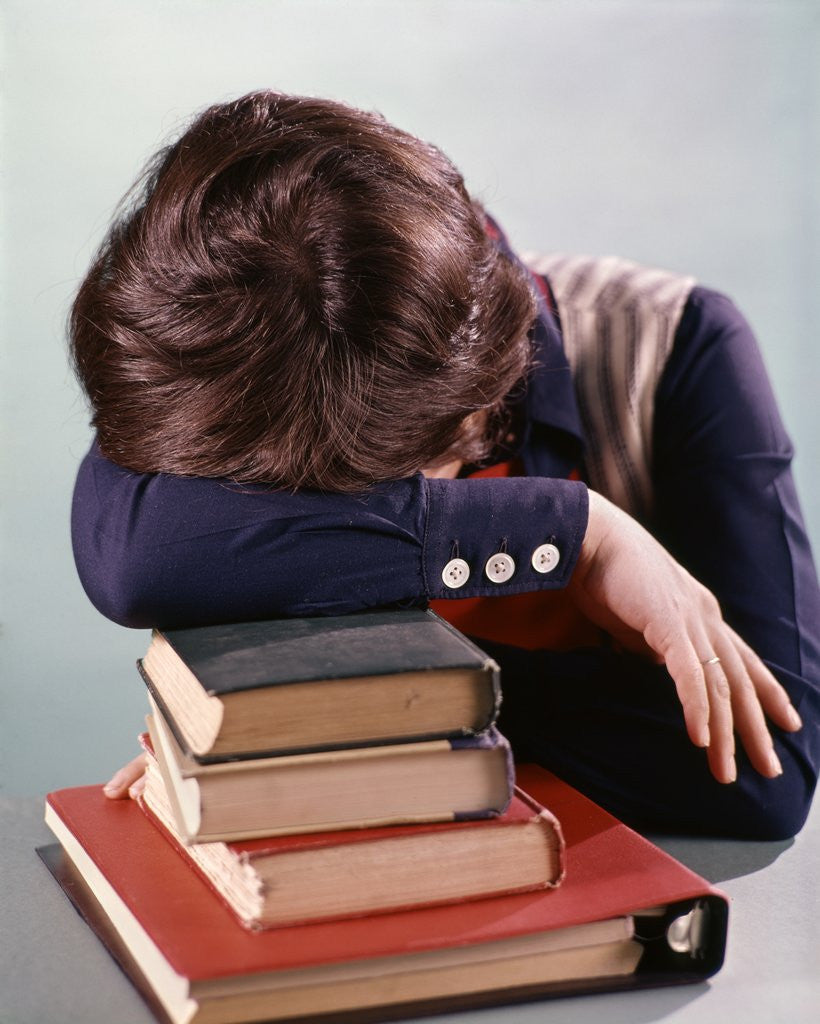 Detail of 1960s 1970s Female Student Head Down On Pile Of Books Asleep Exhausted by Anonymous