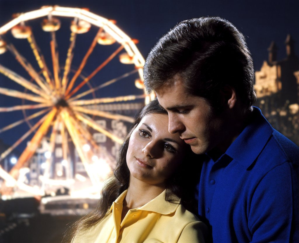 Detail of 1960 1960s 1970 1970s Couple Man Woman Romantic Head To Head Lights Of Ferris Wheel Amusement Park Background by Corbis