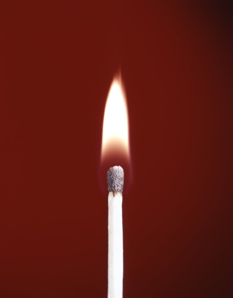 1970s Burning Wooden Safety Match On Red Background Flame by Corbis