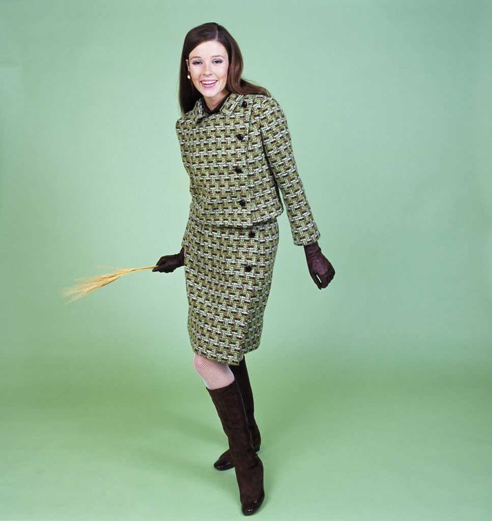 Detail of 1960s Young Woman Modeling Green Wool Knit Two Piece Suit Fishnet Stockings Boots Full Length Clothes Retro by Anonymous