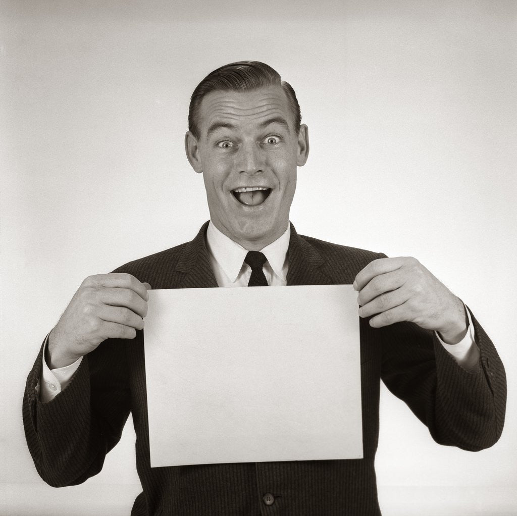 Detail of 1950s 1960s Excited Businessman Looking At Camera Holding Blank White Card by Anonymous