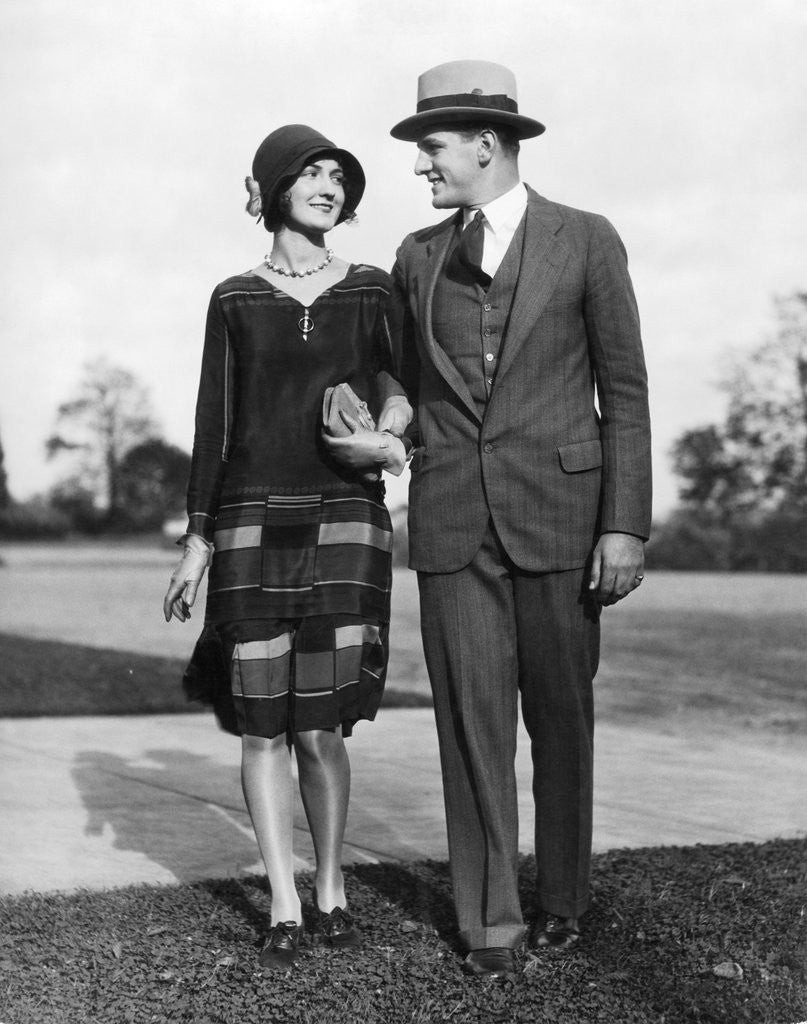 Detail of 1920s Portrait Smiling Stylish Couple Walking Arm In Arm by Anonymous