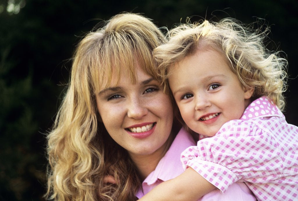Detail of 1990s Portrait Of Mother And Daughter Outdoors Looking At Camera Wearing Pink Shirts by Anonymous