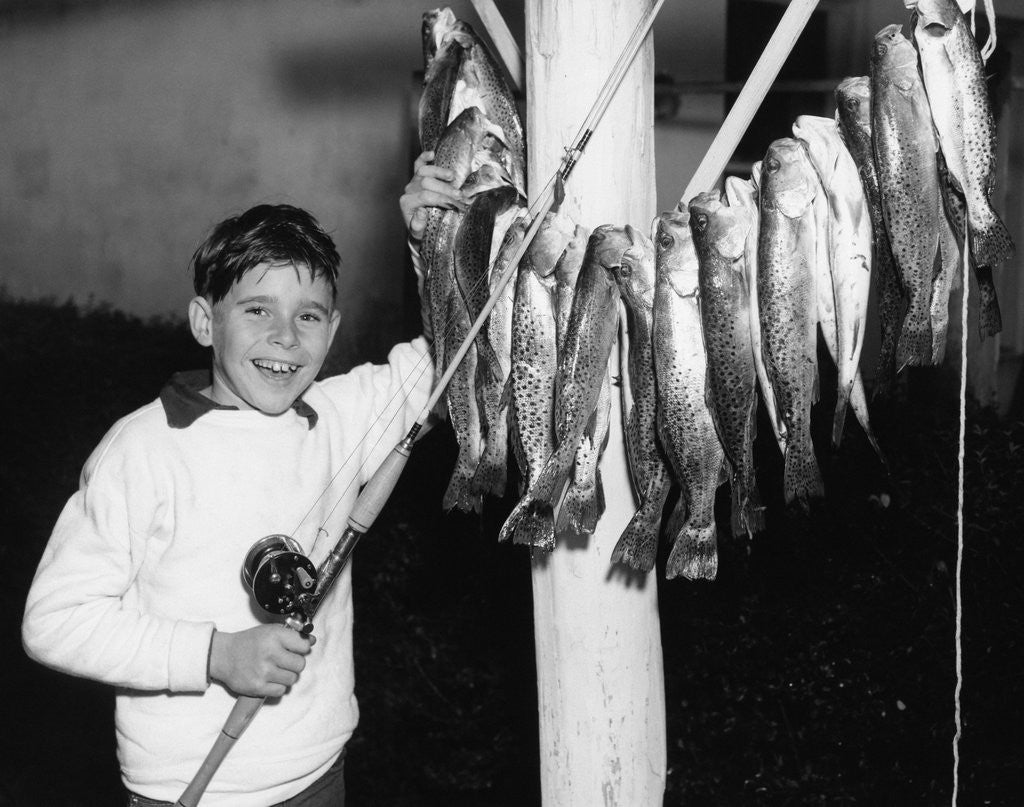 Detail of 1950s Smiling Boy Proudly Displaying His Fish Catch Looking At Camera by Anonymous