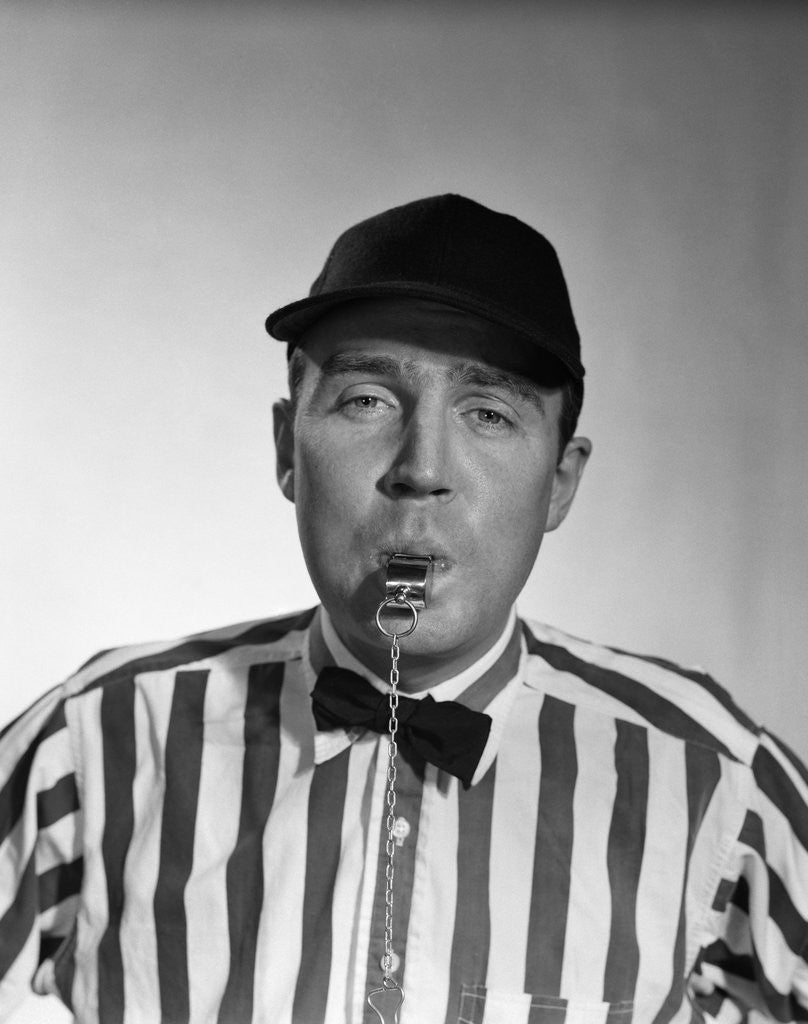 Detail of 1950s Football Referee Blowing Whistle Looking At Camera by Corbis