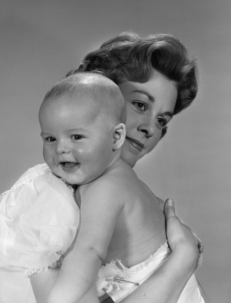 Detail of 1960s Thoughtful Pensive Mother Holding Happy Baby Child by Corbis