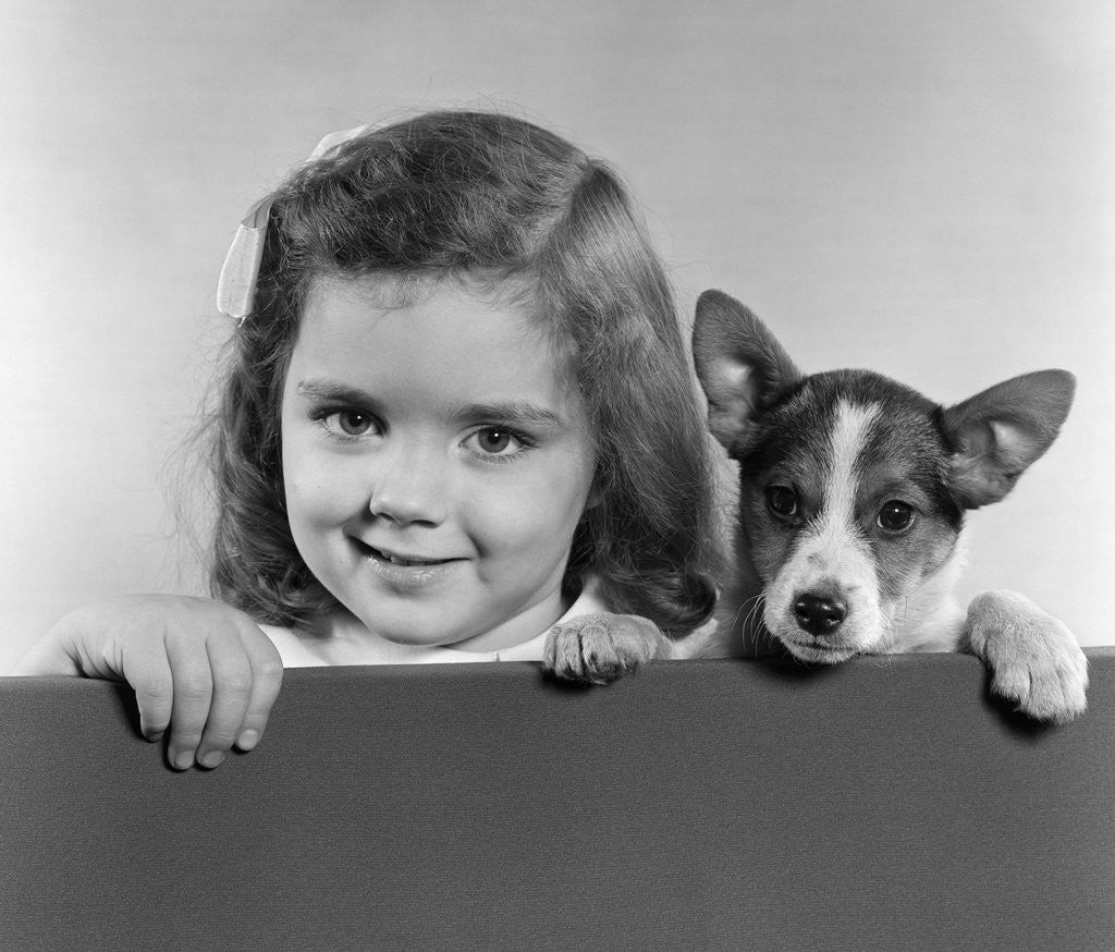 Detail of 1940s 1950s Portrait Of Little Girl With Small Dog Looking At Camera by Anonymous