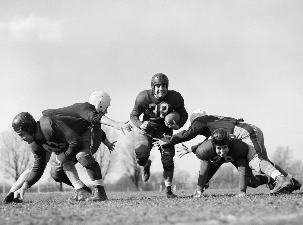 Detail of 1940s 1950s Five Young Men Wearing Leather Helmets And Uniforms Playing Football by Anonymous