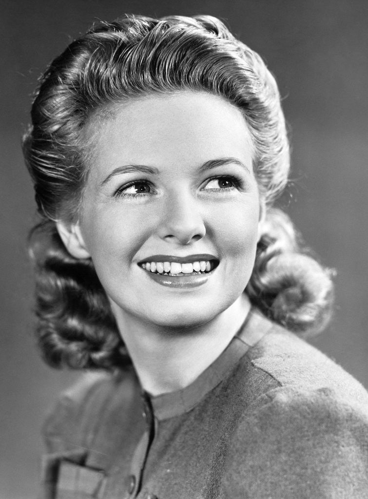 Detail of 1940s Portrait Of Smiling Woman With Long Blond Curly Hair by Corbis