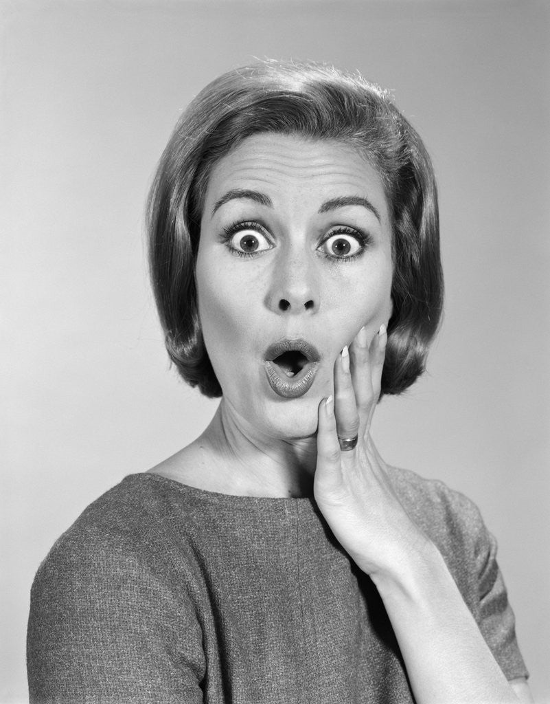 Detail of 1960s Portrait Woman With Hand On Cheek Looking At Camera With Shocked Expression by Corbis