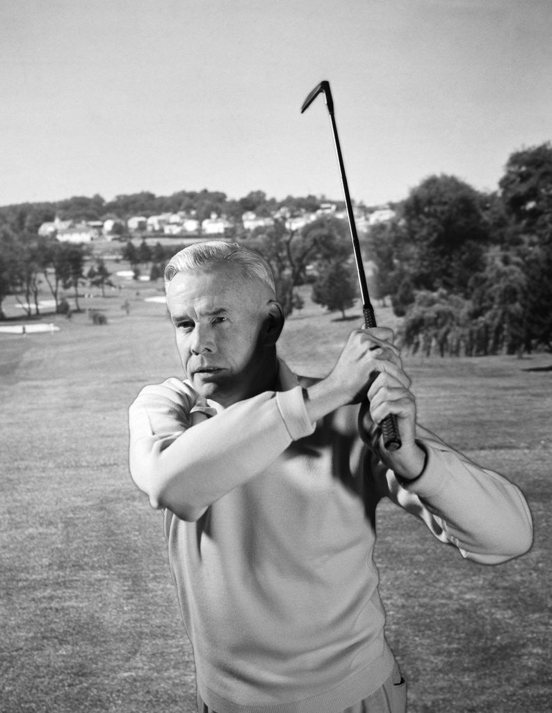 Detail of 1960s Man Playing Golf Hitting Golf Ball From Fairway With Iron Club by Corbis