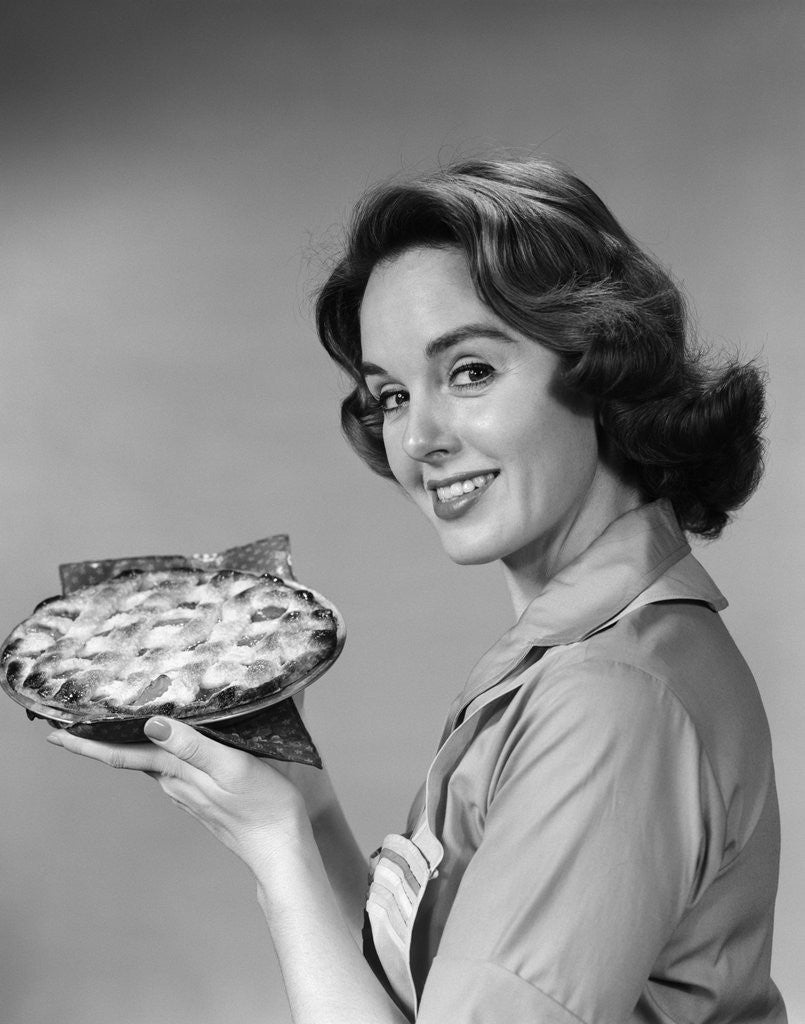Detail of 1950s 1960s Smiling Woman Holding Freshly Baked Pie Looking At Camera by Anonymous