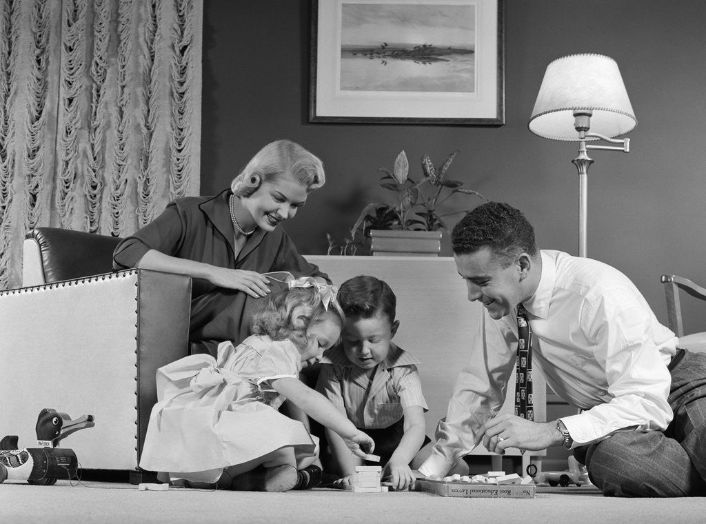 Detail of 1950s Family Of 4 Gathered In Living Room Playing With Letter Blocks by Corbis