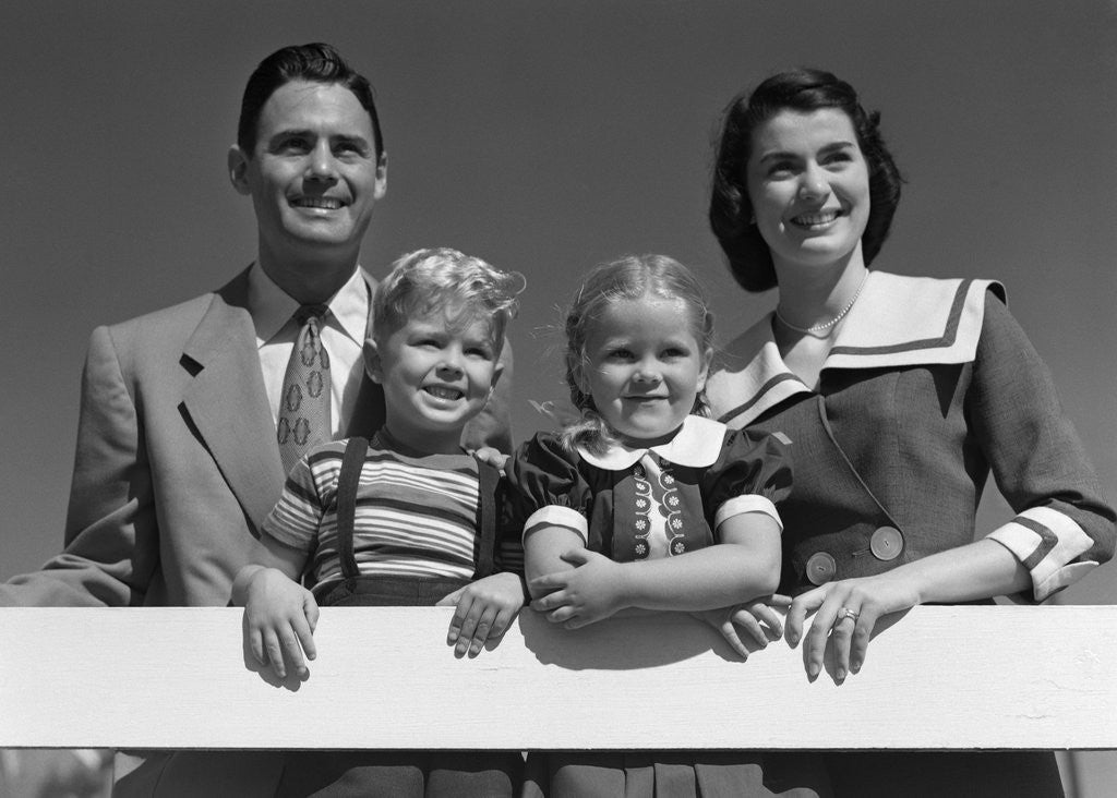 Detail of 1950s Portrait Smiling Family Father Mother Daughter Son Standing Together Behind White Fence Outdoor by Anonymous