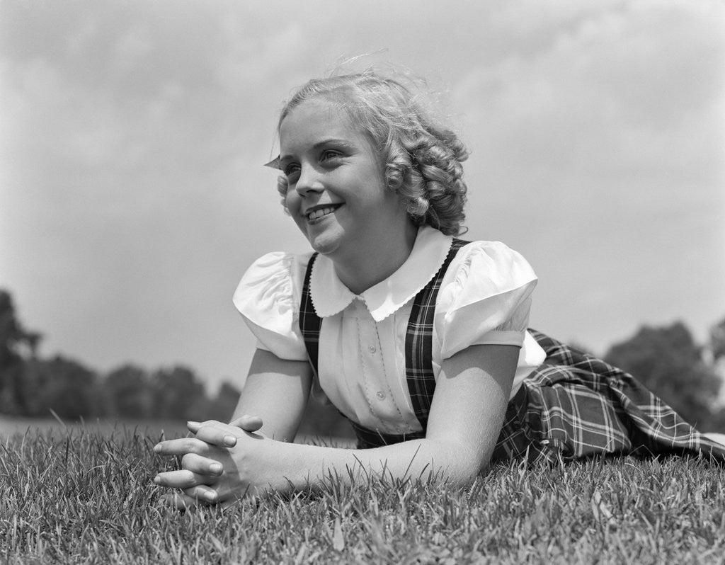 Detail of 1940s Blond Girl Smiling Lying On Grass by Anonymous