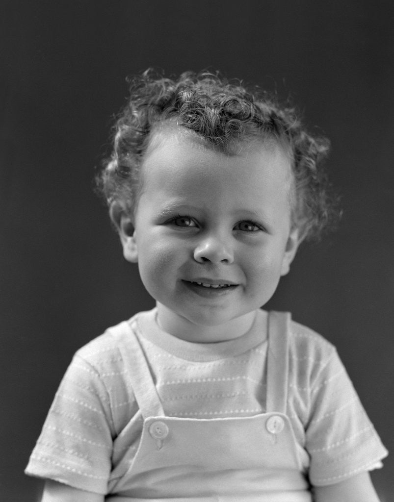 Detail of 1940s Curly Haired Little Boy Portrait Smiling Looking At Camera by Anonymous