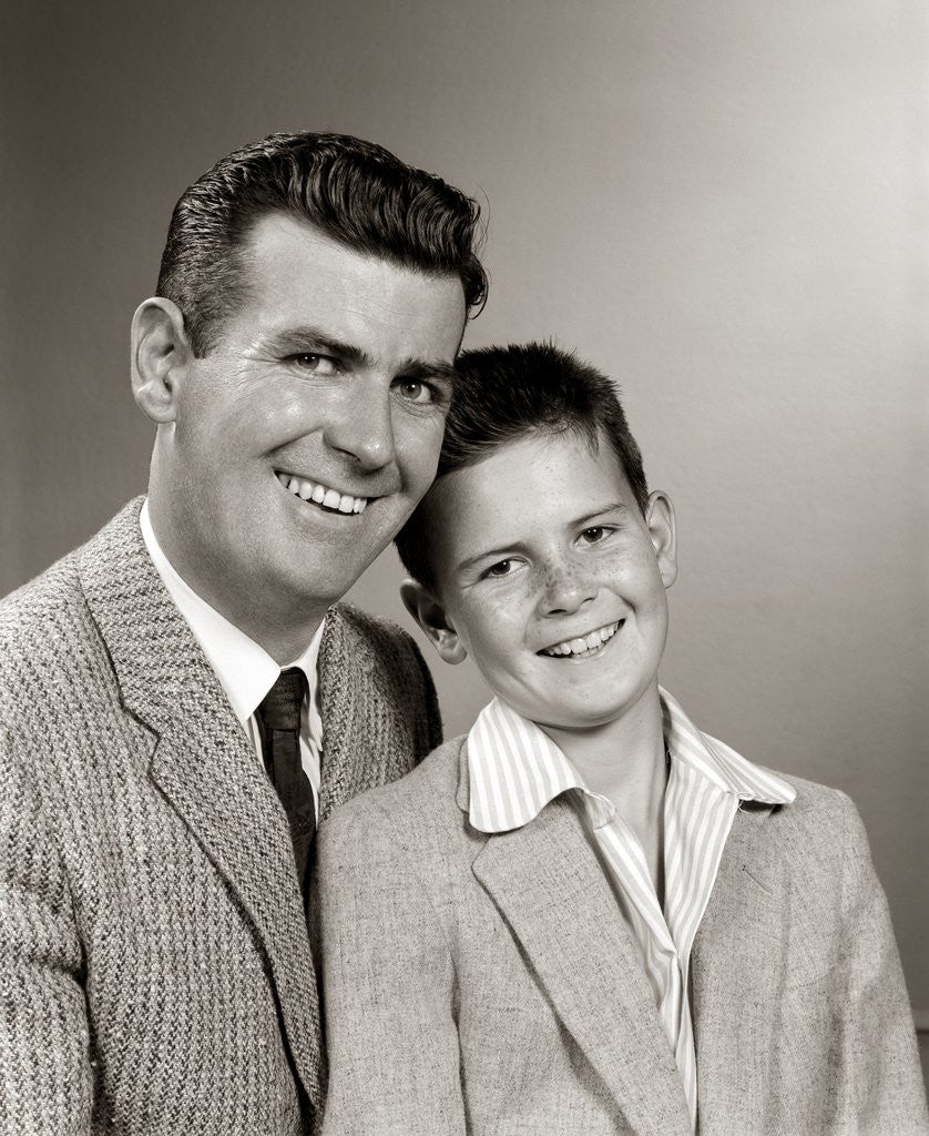 Detail of 1950s Studio Portrait Smiling Man Father And Boy Son Sitting Together Looking At Camera by Anonymous