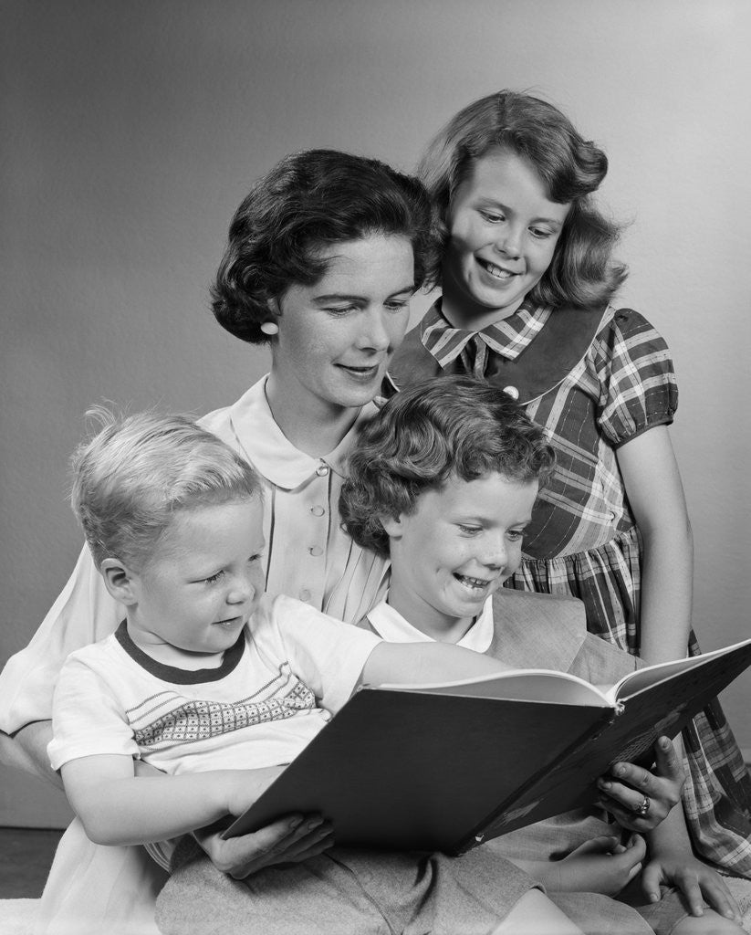 Detail of 1950s Portrait Mother Two Daughters And Son Reading Book Together by Anonymous