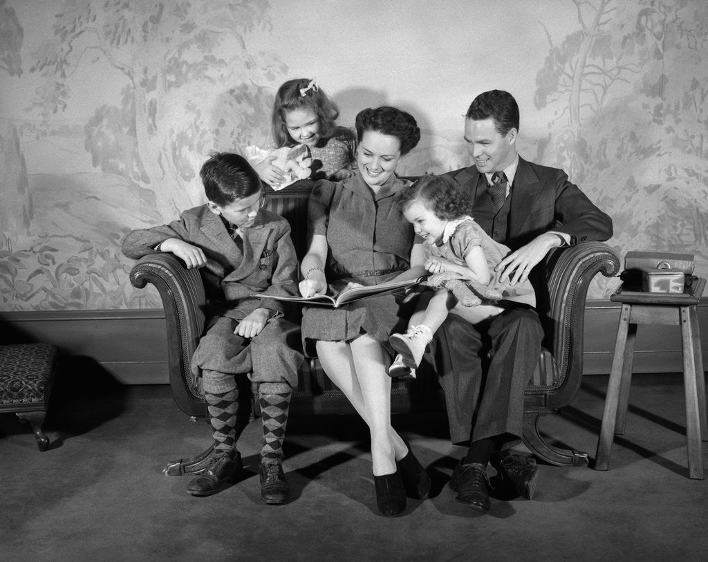 Detail of 1930s 1940s Family Sitting On Couch Looking Reading Book Together by Anonymous