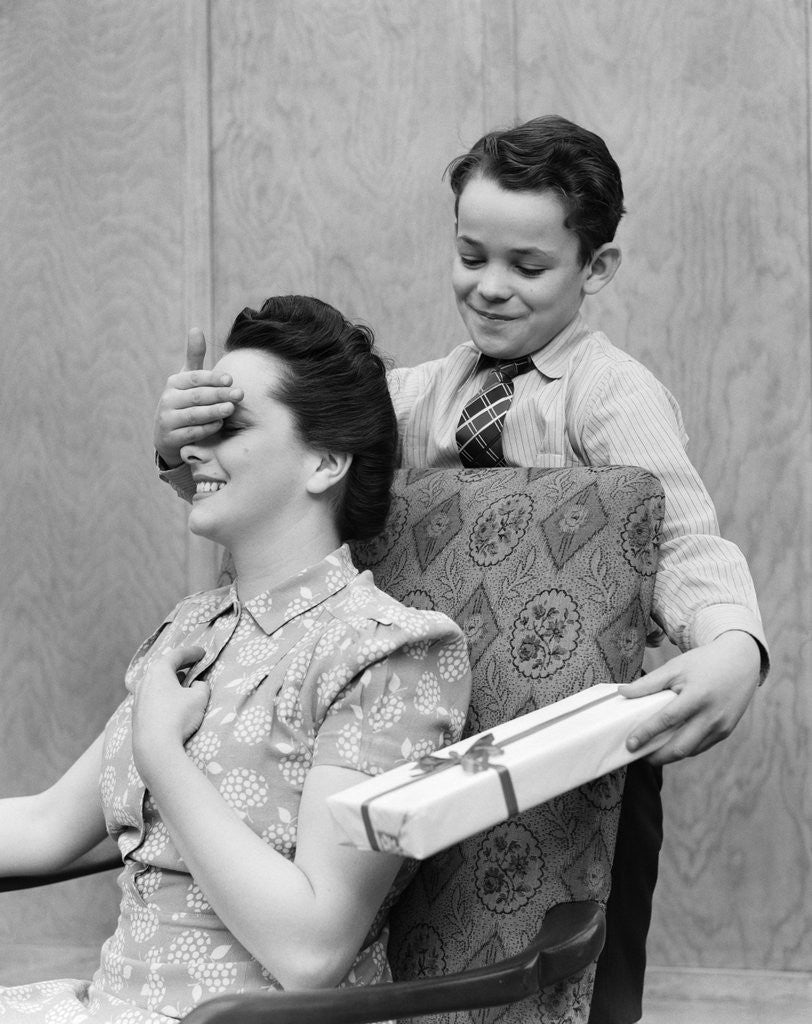 Detail of 1930s 1940s Boy Son Surprising Woman Mother With Gift Wrapped Present by Corbis