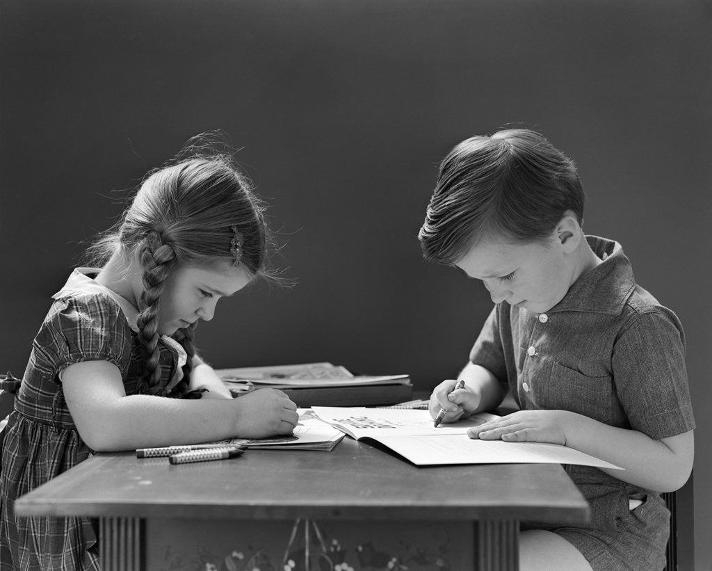 Detail of 1940s Boy And Girl Sitting At Table Coloring In Books by Anonymous