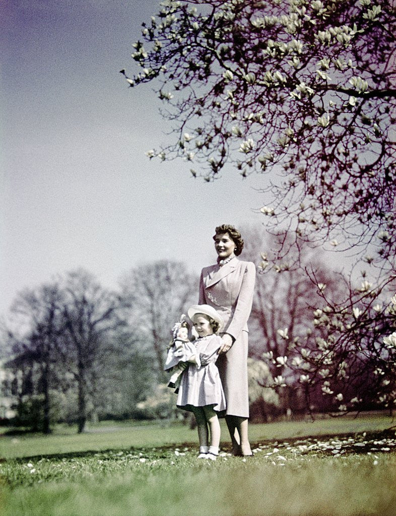 Detail of 1940s Woman Mother Girl Daughter Standing In Blossoming Spring Landscape by Corbis
