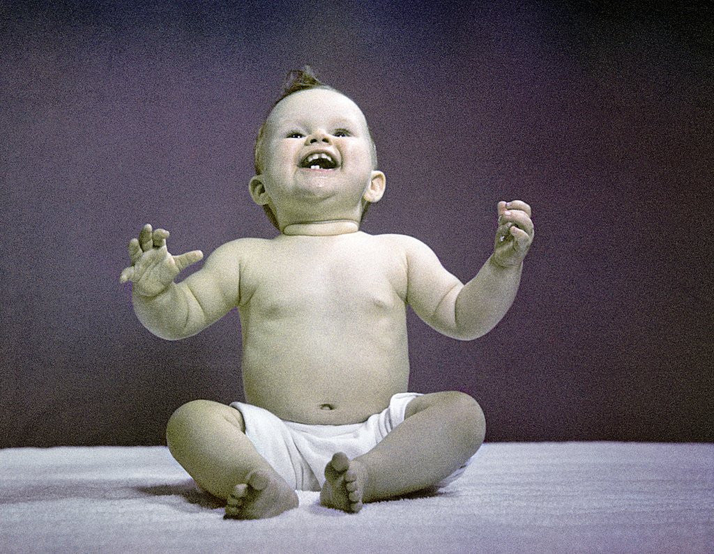 Detail of 1940s 1950s Full Body Sitting Baby Laughing Hands Arms Raised by Corbis