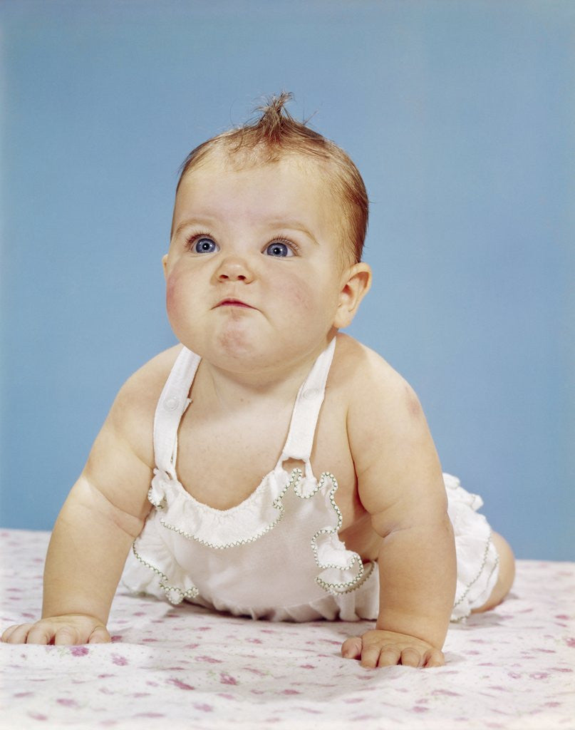 Detail of 1960s Baby Making Funny Face Pushed Up On Arms Crawling Forward by Anonymous