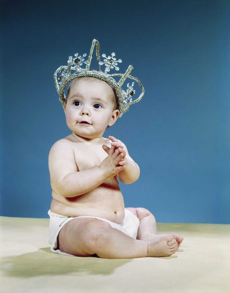 Detail of 1960s Smiling Baby Wearing Rhinestone Queens Crown Or Princess Tiara by Anonymous