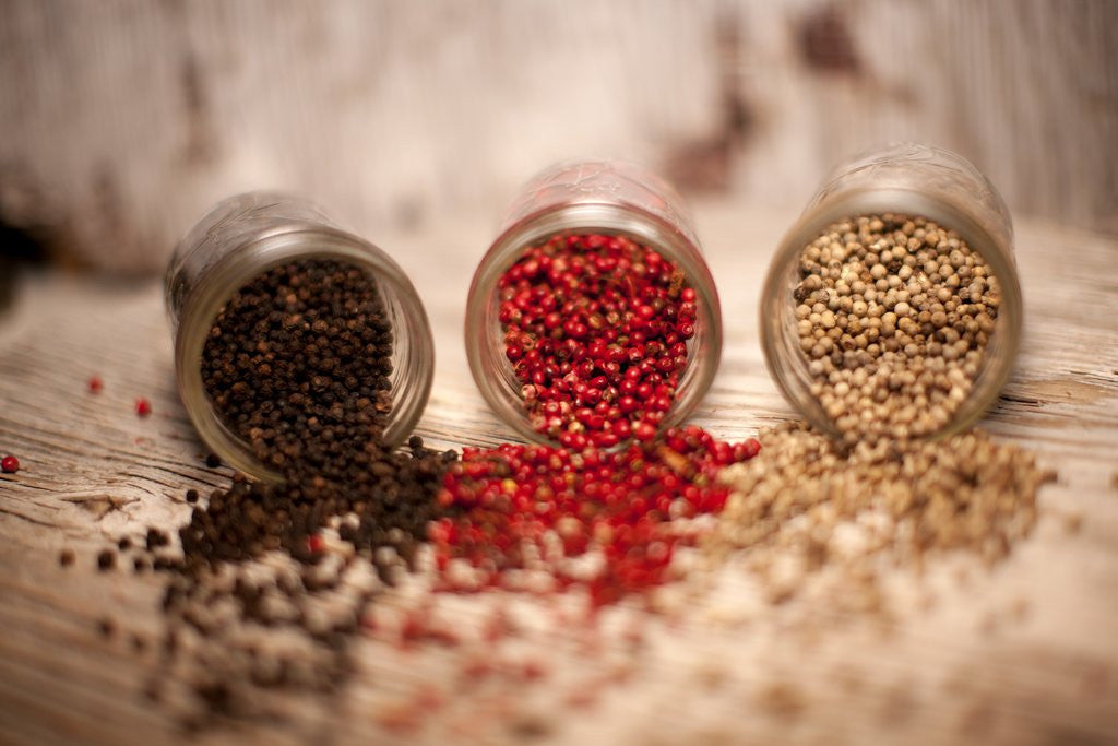 Detail of Black, red, and white pepper corns in rustic mason jars by Anonymous
