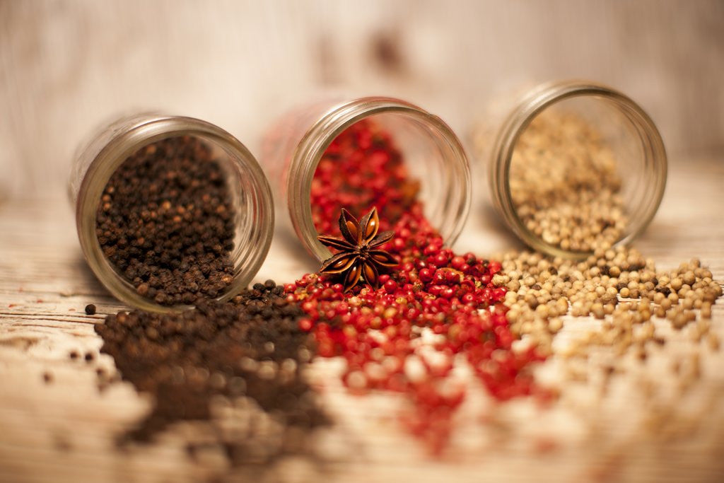 Detail of Black, red, and white pepper corns in rustic mason jars by Anonymous