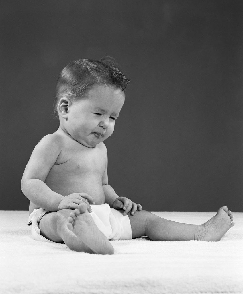 Detail of 1950s baby wearing diaper and making a funny face by Corbis