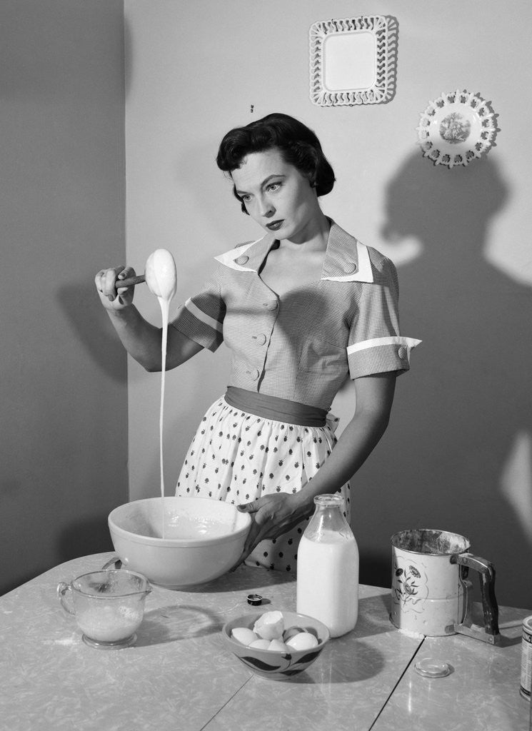 Detail of 1950s housewife mixing sticky batter in kitchen by Corbis