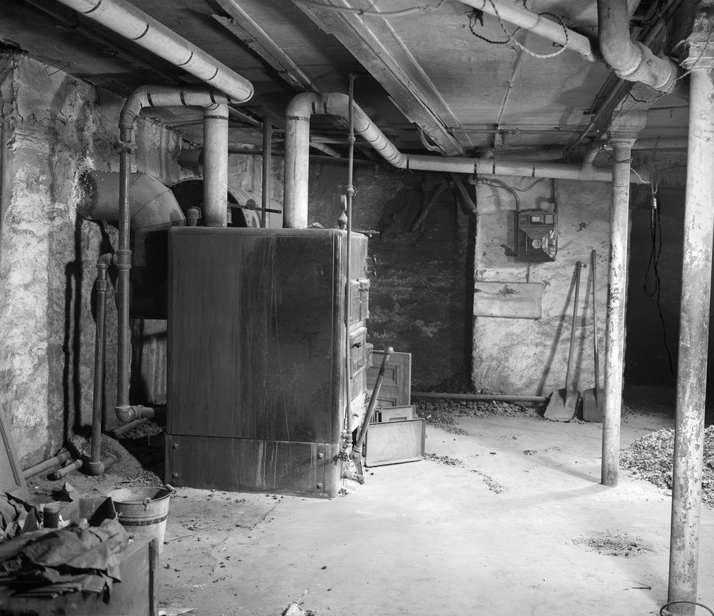 Detail of 1930s 1940s coal burning home furnace in basement by Corbis