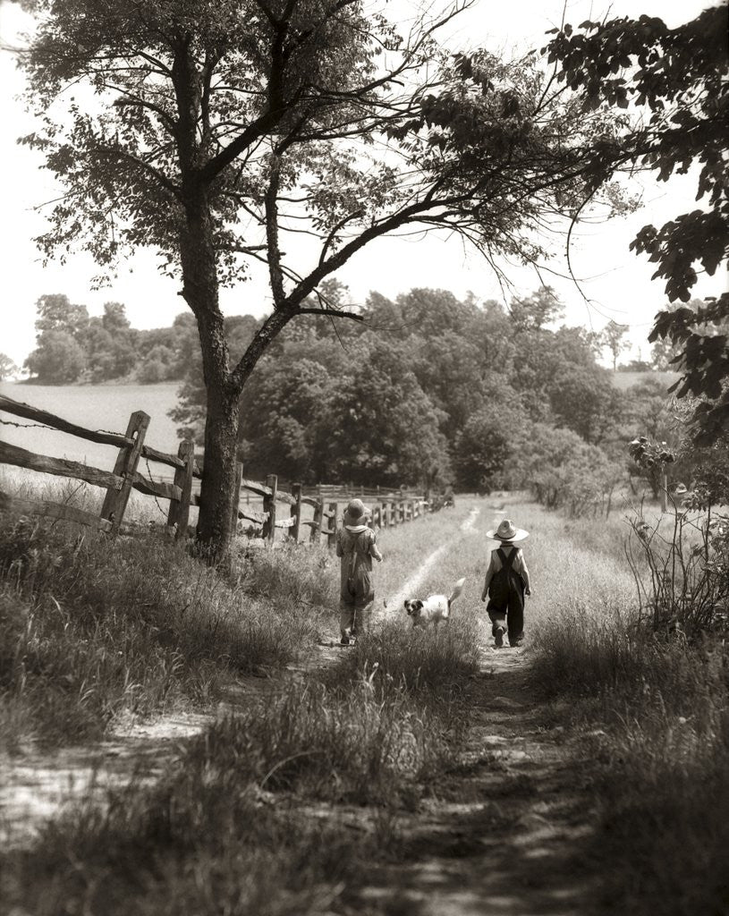 Detail of 1930s boy and girl in straw hats walking down farm road by Anonymous