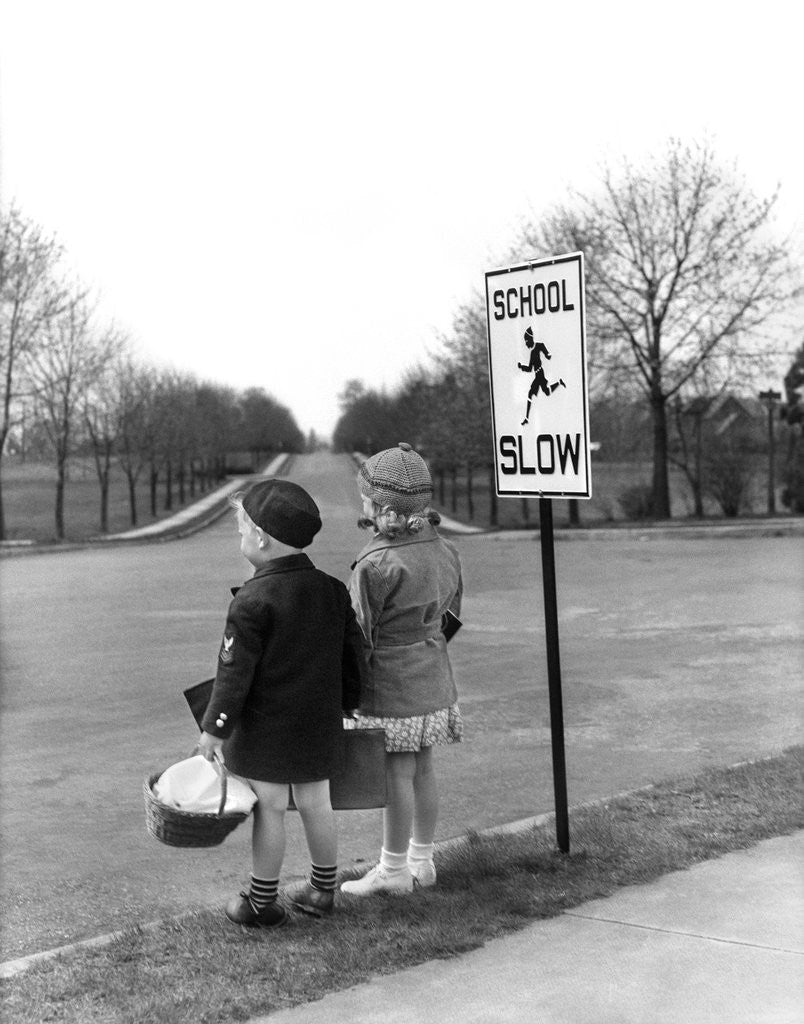 Detail of 1930s 1940s boy and girl waiting to cross the road by Anonymous