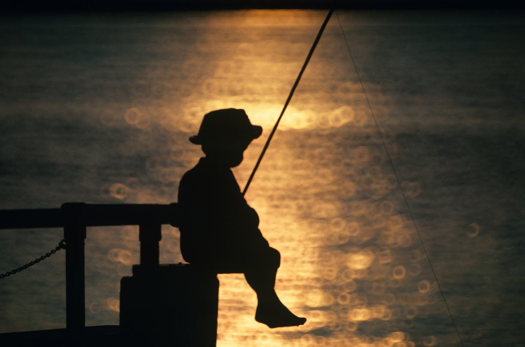Detail of Silhouette of child fishing off a dock at sunset by Anonymous
